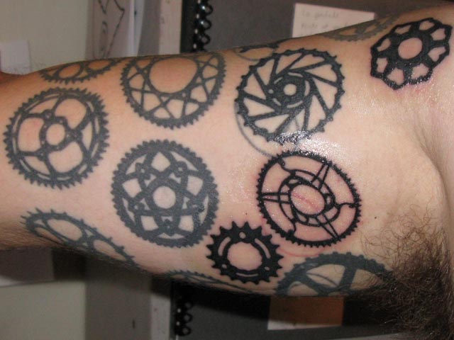 He has a ton of chainring tattoos, and a whole bunch more in the works.